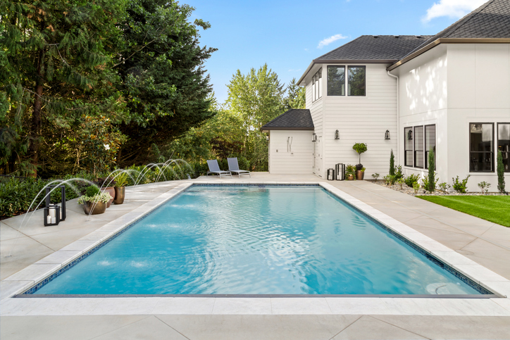 Clean Swimming Pool in Backyard of Home