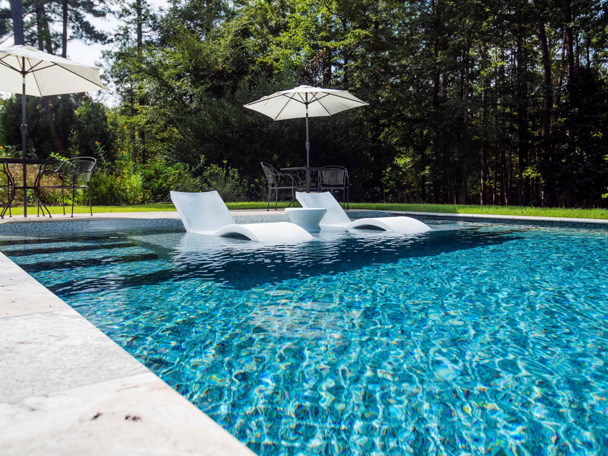 Swimming pool with lounge chairs and umbrella