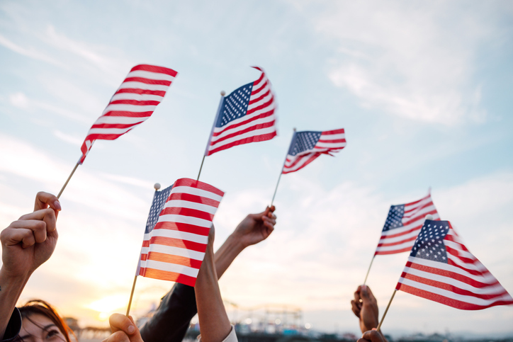 People waving US flags for holidays celebration