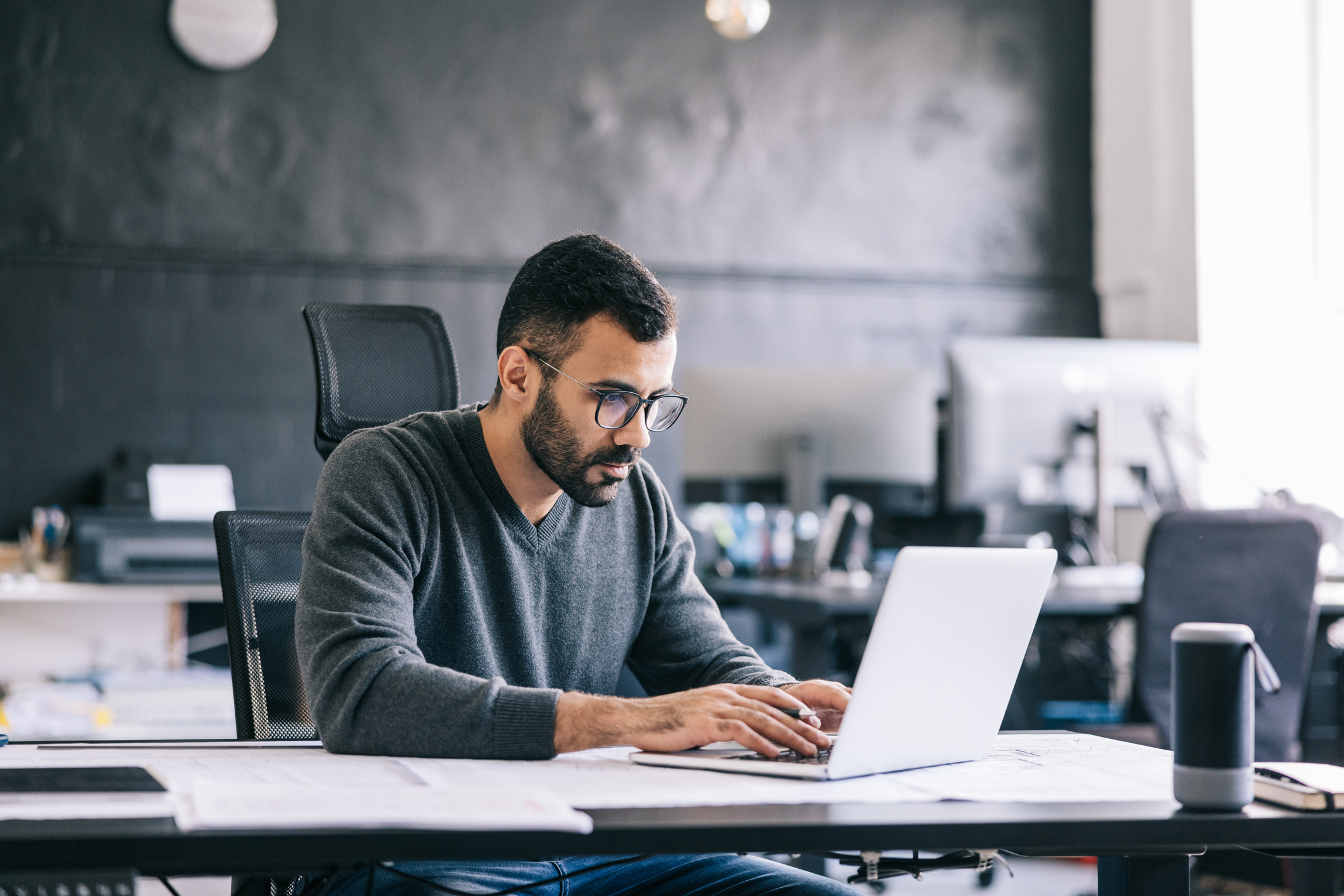 Corporate employee in office at computer