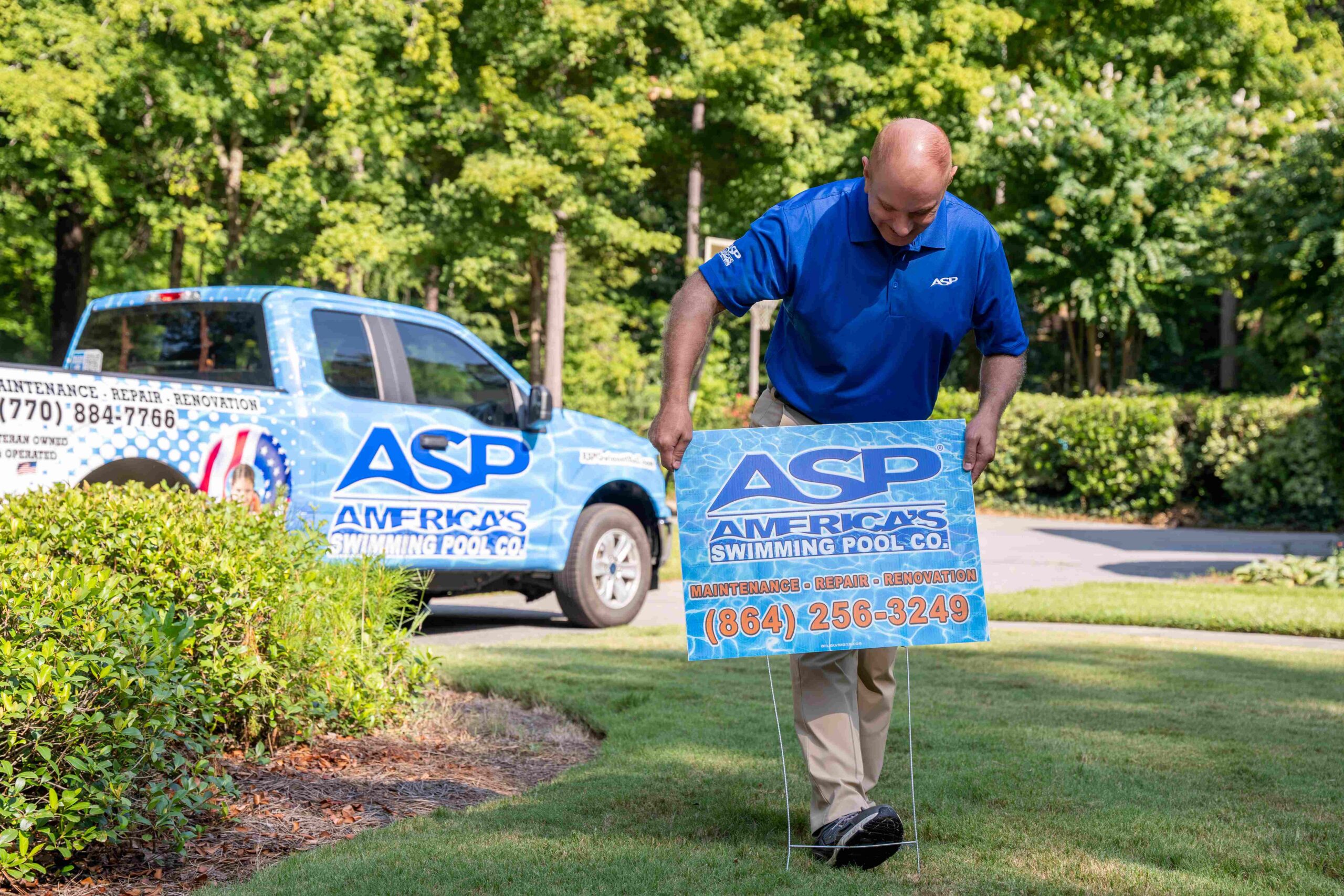 ASP Franchise owner putting yard sign in grass