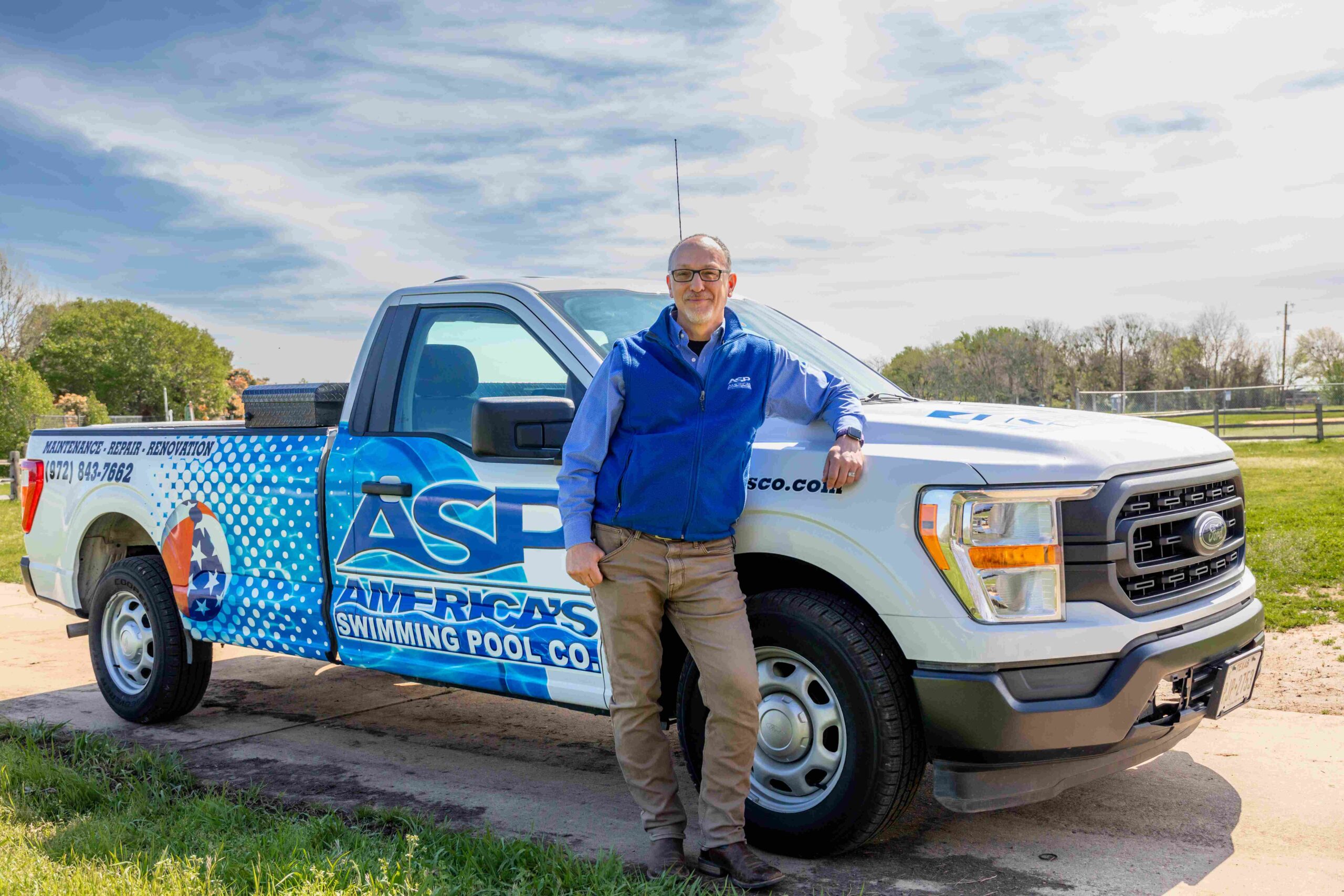 America's Swimming Pool franchise owner standing beside truck